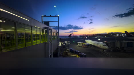 delta airplane at airport gate during twilight