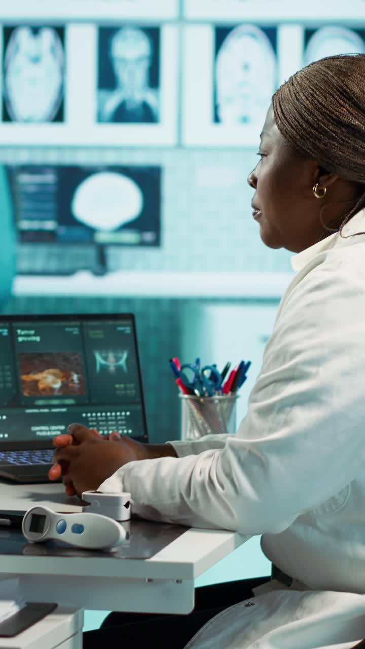 African American Doctor Analyzing Medical Data on Laptop in Lab
