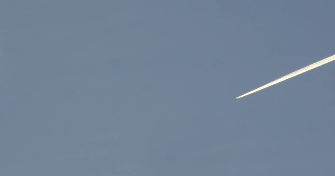 Campo lungo che guarda in alto la scia di condensazione di un aereo, a Rhyl.