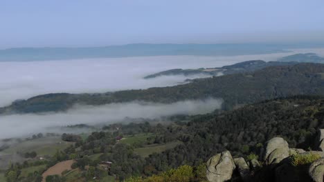 aerial drone view from uchon of rural landscape shrouded in fog, saone-et-loire department in france