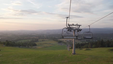 summer panorama with ski lift with no people, panning left