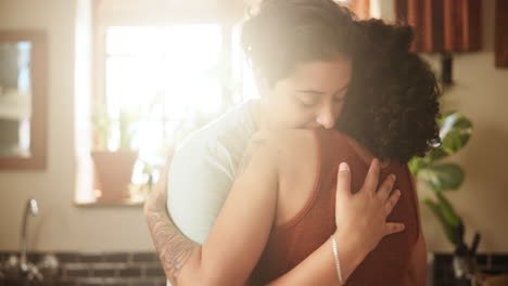 two women hugging in a kitchen