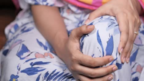woman holding her knee in pain