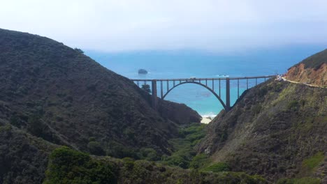 Bixby-Bridge-over-Mountain-Canyon-on-California-Big-Sur-Coast,-Aerial-Drone-Flight