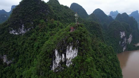 Laozhai-Hill-with-pagoda,-antenna-and-mountain-karstic-relief,-China