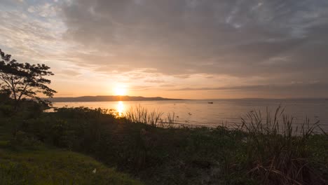 A-beautiful-moving-time-lapse-of-the-sun-rise-over-Lake-Victoria-in-East-Africa-with-fishermen-in-wooden-canoes-out-on-the-calm-water