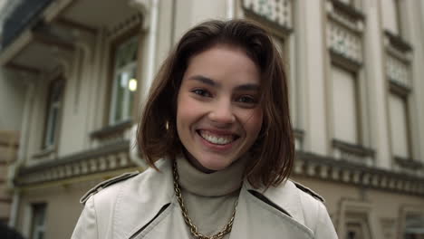 una chica alegre riendo en la calle.