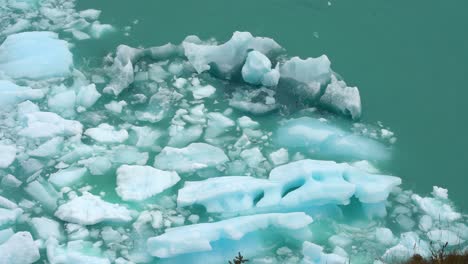 Icebergs-Floating-by-Coast-in-Turquoise-Ocean-Water,-Close-Up