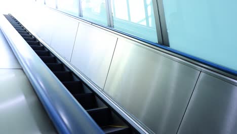 escalator moving in an empty airport terminal