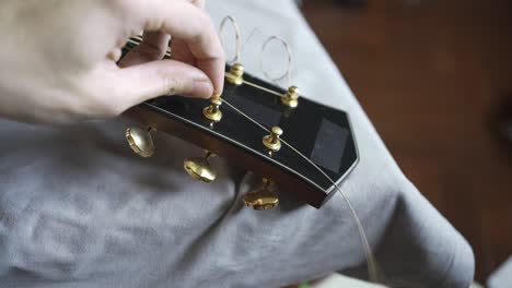 put a new guitar string on an acoustic guitar