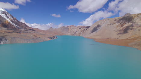 blue lake tilicho nepal drone shot, world's highest altitude lake annapurna mountain circuit, sunny weather landscape, country asset 4k