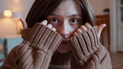 young woman with wide eyes expressing fear, surprise, or shyness