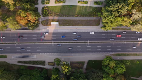 Aerial view of a city street with traffic and surrounding park areas