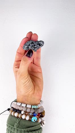 hand holding a grey and black stone