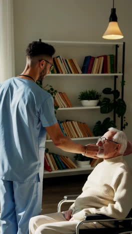 caregivers providing assistance to an elderly man in a wheelchair