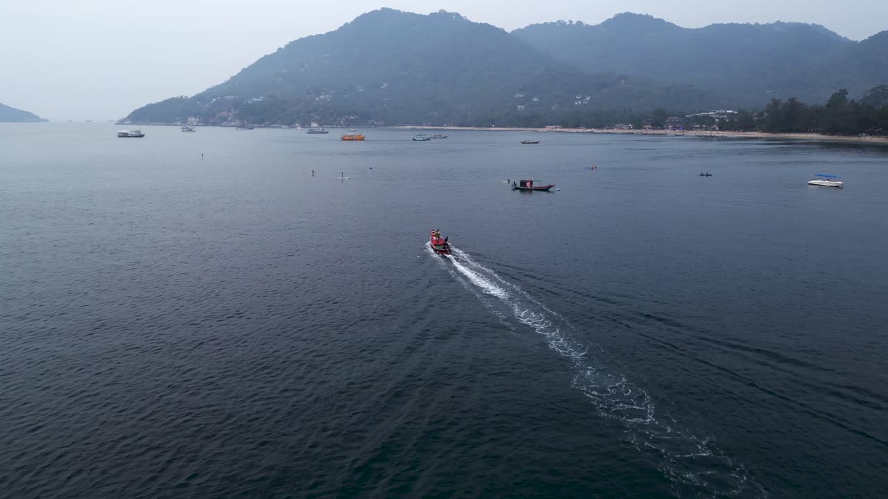Boat cruising along a tropical island coastline