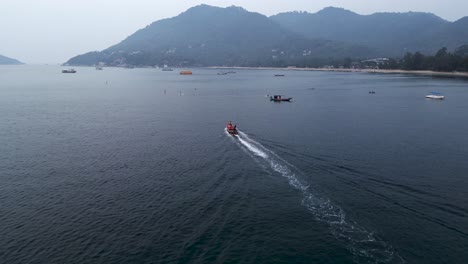boat cruising along a tropical island coastline