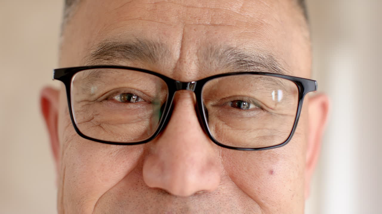 Close-up of senior man's eyes wearing glasses, expressing warmth and joy