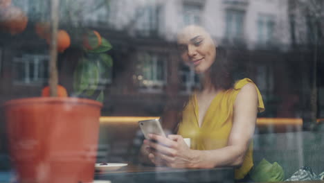woman using smartphone in a cafe