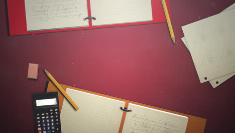 Closeup-table-of-student-with-notebook-and-calculator-school-background