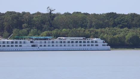 a cruise ship sails along a river