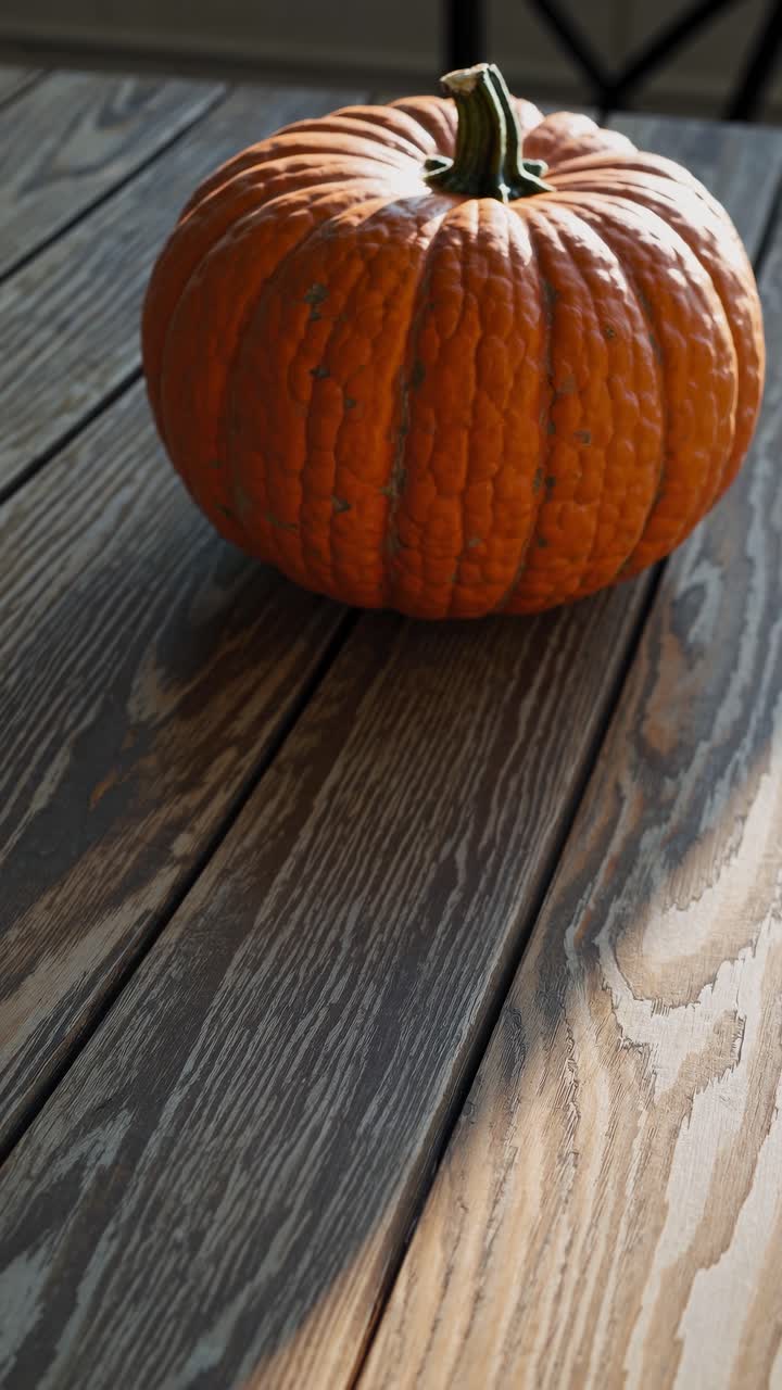 A rustic video concept featuring a pumpkin on a wooden table