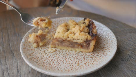 close up of a delicious apple pie with crumble topping on a plate