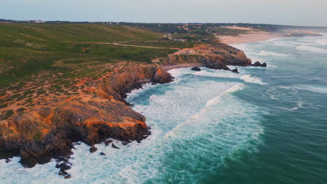 ocean waves splashing rocky coast morning seascape. aerial sea crashing cliffs