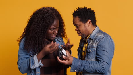 African-american-married-couple-looking-for-money-inside-the-leather-wallet