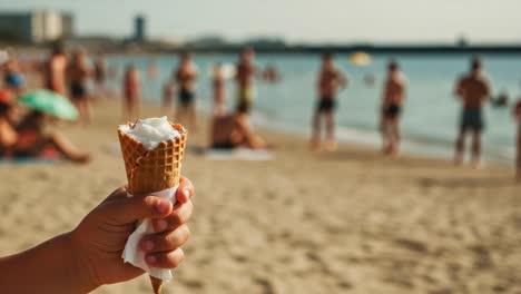a sunlit beach scene featuring a hand holding an ice cream cone with a crowd of sunbathers and swimmers in the background, perfect for summer vibes