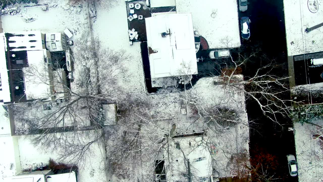 Snow covered rooftops of West Babylon, aerial drone top down view
