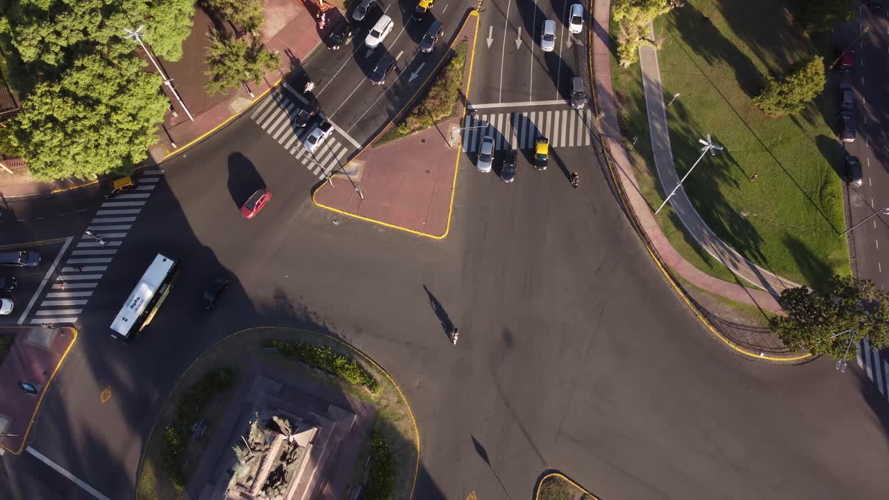 Aerial top down shot of traffic in roundabout of Sarmiento Avenue in Buenos Aires City at sunset time