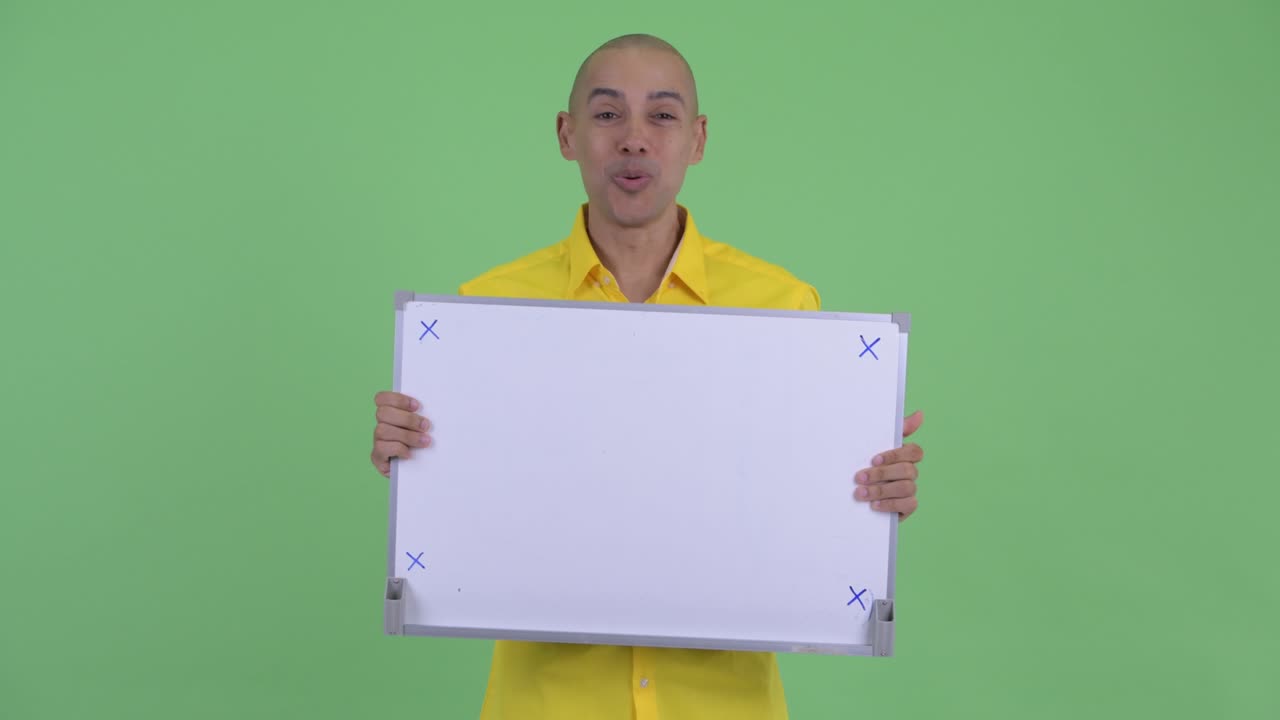 Happy handsome bald businessman with white board