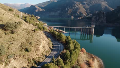 canales reservoir with still water in a province of granada with mountains on both sides of its banks