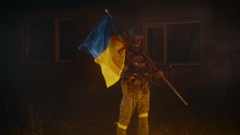 ukrainian soldier with flag in war zone