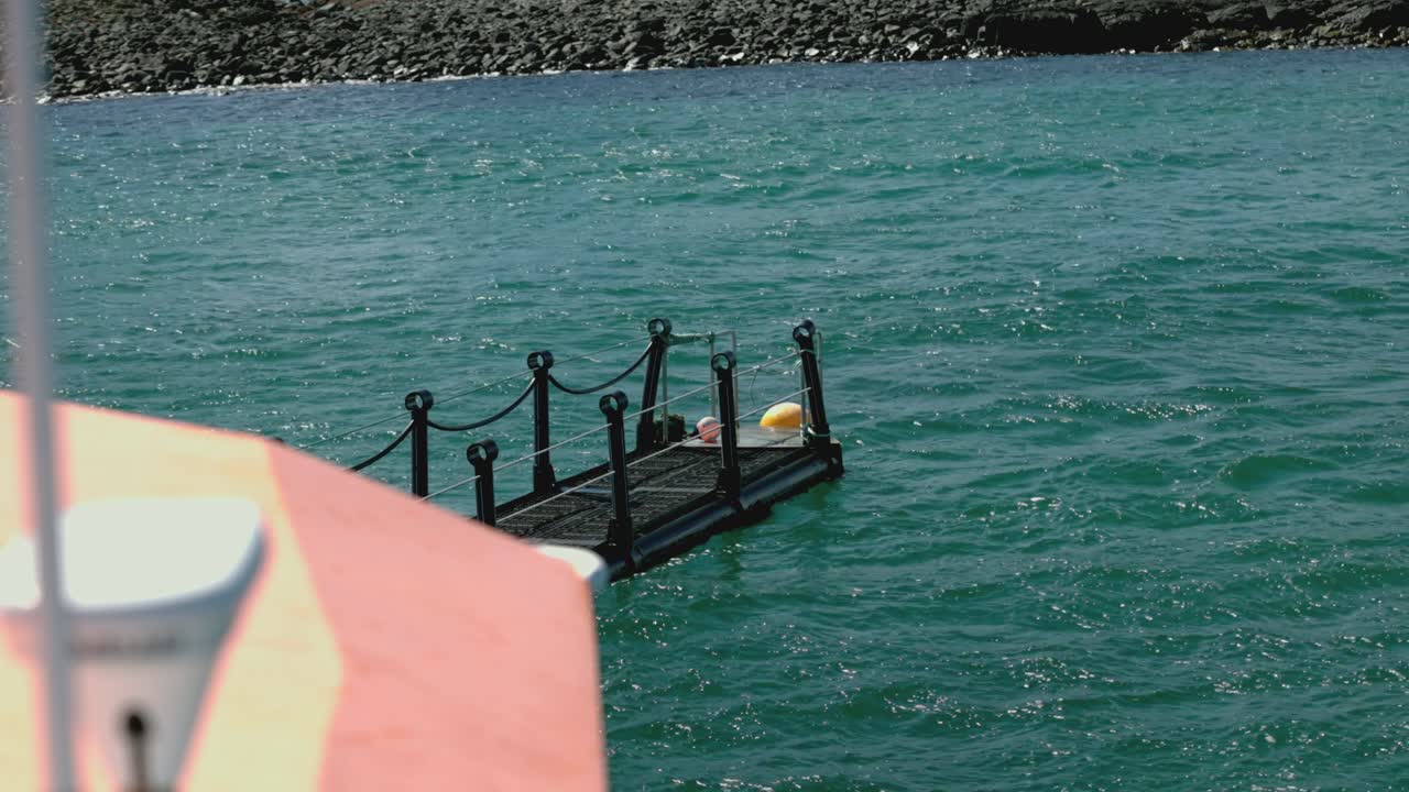 Hand-held shot of a boat moving the jetty towards Lunga Island to dock