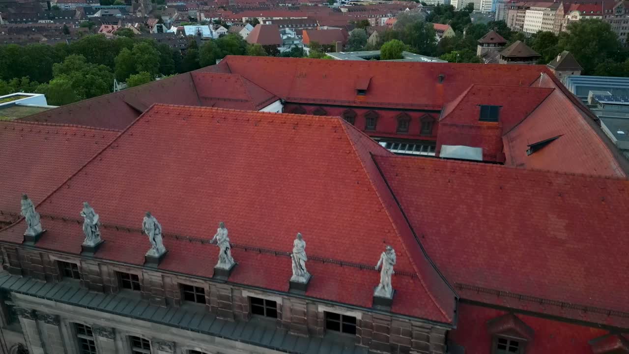 4K Aerial Drone Video of the Statues on the Roof of the Bavarian Trade Museum in Downtown Nurnberg, Germany