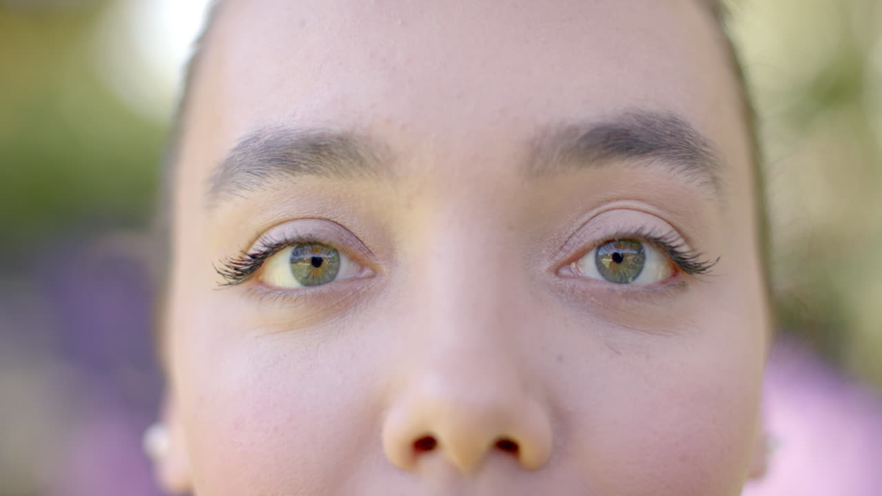 Close-up of woman's eyes with natural makeup, focusing on green eye color