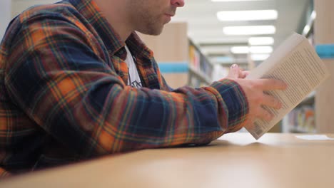 Man-flipping-through-the-pages-of-a-book