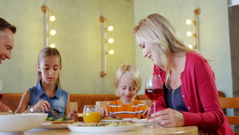 family having meal together in restaurant 4k