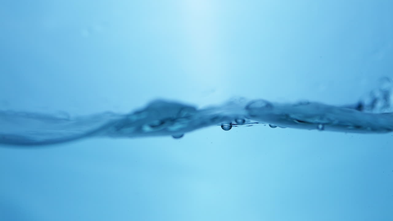 Refreshing Aqua Clean Water Droplets Cascading in Slow Motion