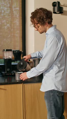 person making coffee in a modern kitchen