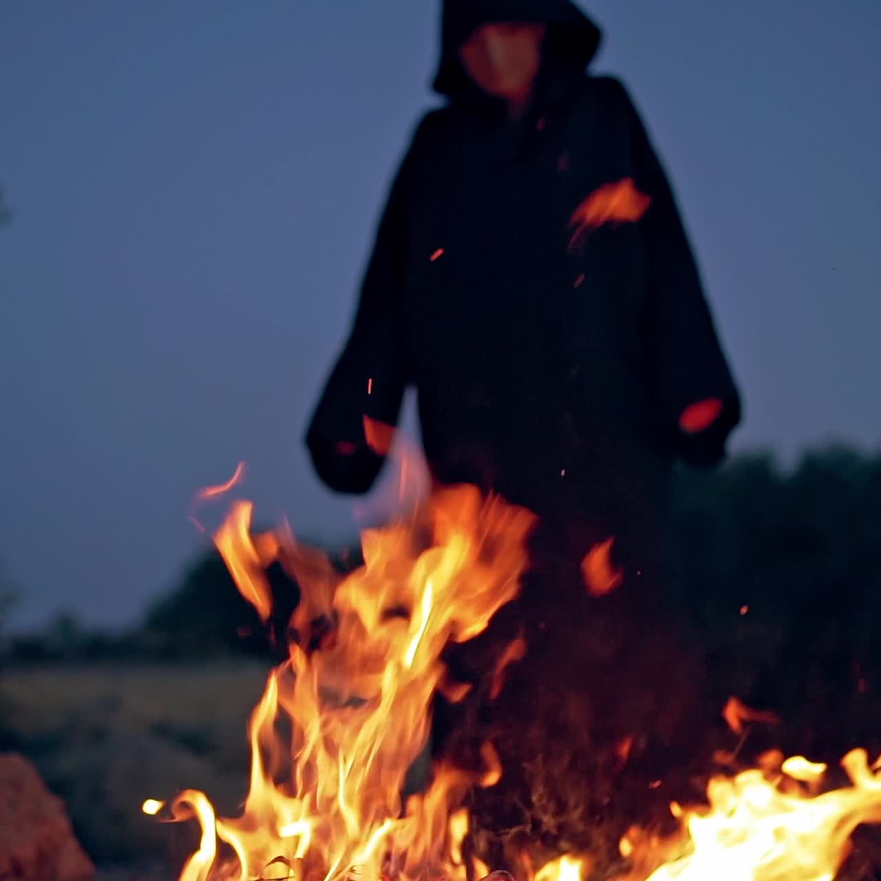 Witch conjure near bonfire