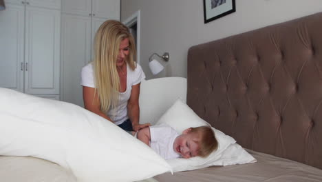 family spending free time at home. cheerful family having fun with their daughters on the bed