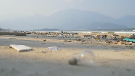 light bulb on rubbish-filled beach