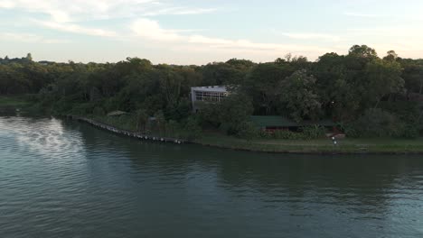 Stunning-aerial-view-of-the-green-environment-along-the-Paraná-River-in-Posadas,-Misiones,-Argentina,-at-the-iconic-tri-border-area-with-Brazil-and-Paraguay