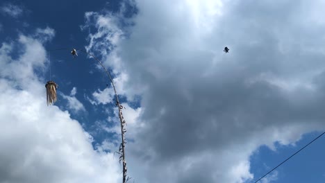 balinese penjor religious decoration for galungan and kuningan holiday with flying kites on tropical island bali indonesia