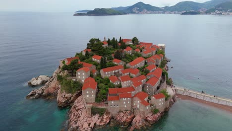 springtime aerial view of sveti stefan old town montenegro with red roofs and adriatic waters