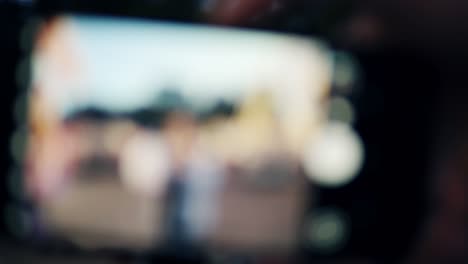 Steadicam-shot-of-a-young-girl-in-trendy-glasses-in-amusement-park-taking-candy-cotton.-Close-up-shot-of-camera-display