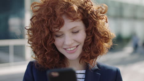 beautiful young business woman laughing texting on phone portrait of red head college student corporate